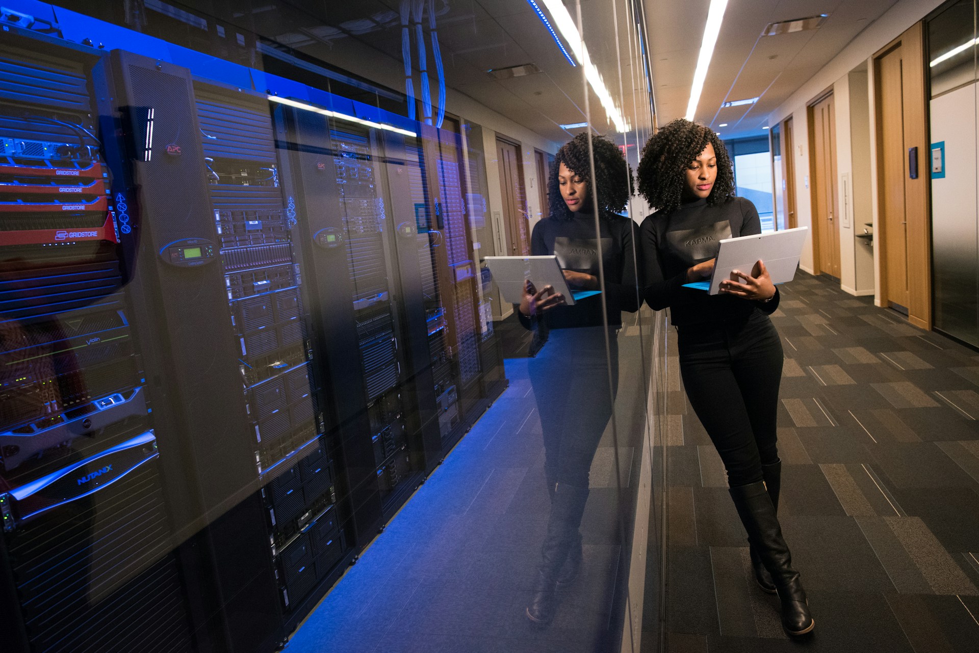 Female tech manager working in data center uses laptop powered by Kinetic Business